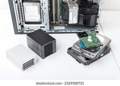 Closed-up view of hard disk drives with a PC in the background. Upgrade, repair and data recovery concept
