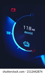 Close-in shot of electric car battery range gauge in blue - Shutterstock ID 2112442874