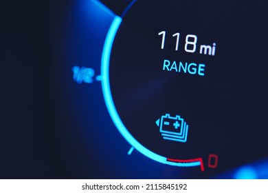 Close-in shot of electric car battery range gauge in blue - Shutterstock ID 2115845192