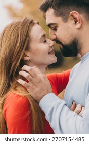 closeknit pair displaying warmth and affection, couple sharing loving gaze in autumn setting