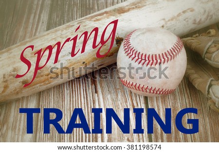 Closely cropped image of old, worn baseball equipment on a wooden background including a bat, mitt and ball. Vintage filter applied and spring training message added in red and blue. Horizontal image.