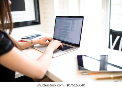Closely woman blogger typing lifestyle text on netbook before publication in social network. Female professional business plan writer keyboarding on laptop computer. Skilled programmer using notebook
