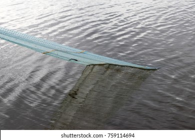 Close-mesh nets to catch fish, which was pulled from the water by fishermen carefully.