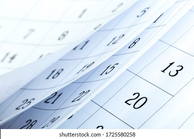 Closes a calendar page in blue. flipping calendar 2020