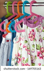 Closet With Baby Dresses On Hangers 