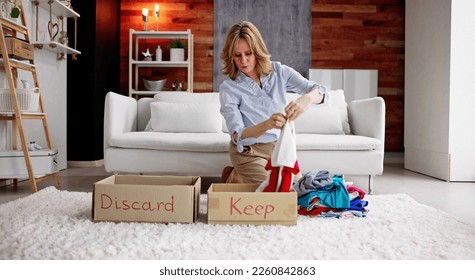 Closet Declutter And Cleaning. Organized Woman Discarding Clothes - Powered by Shutterstock