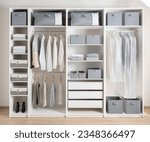 Closet with different clothes and accessories, Clothing Cover in a modern white wardrobe Organizer inside a modern room