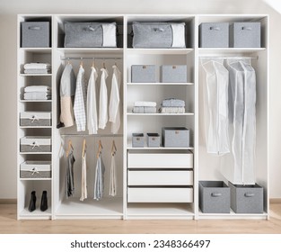 Closet with different clothes and accessories, Clothing Cover in a modern white wardrobe Organizer inside a modern room