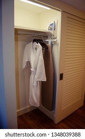 Closet In Hotel Room With Iron, Ironing Board, And Terry Cloth Robe. 