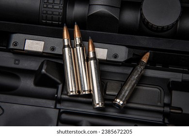 Close-up of .223 carbine cartridges. Dark background.