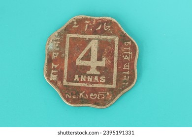 Closeup of a 4 Anna coin of British India depicting George V King Emperor on one side.
