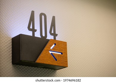 A Closeup Of 404 Hotel Room Number With An Arrow Sign Showing The Direction