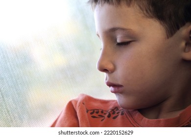 Close-up Of A 6-year-old Boy Sleeping Soundly In A Bus