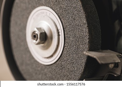 Close-up Of Abrasive Disc On Bench Grinder Machine