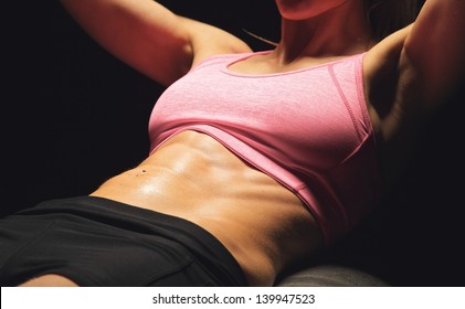 Closeup of the abs of a sportswoman working out
