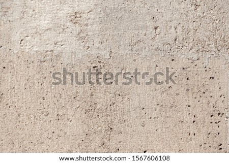 Closeup abstract background of an old wall in beige color.