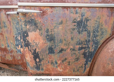 closeup abstract background of rust on an old vehicle or jalopy door