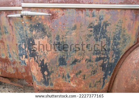 closeup abstract background of rust on an old vehicle or jalopy door