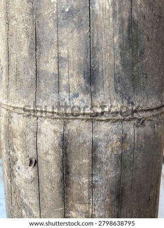 Close-up abstract texture of an old weathered bamboo trunk surface with natural cracks and knots.