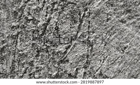 Close-up abstract texture of rough cement plaster wall made from a mixture of sand and cement. Gray grunge concrete surface with uneven, gritty, and scratched pattern showing detailed construction material. Rough stucco wall background with natural cement render texture, perfect for industrial, construction, and architectural concepts. The roughcast finish creates a rugged and durable look, commonly used for exterior and interior building walls. High resolution detail of unfinished concrete plaster, ideal for background, overlay, wallpaper, and design element. Monochrome gray cement texture representing strength, building, renovation, and construction industry.
3