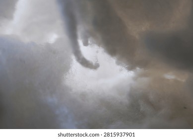 Close-up abstract view of fluffy polyester fiberfill clusters resembling soft clouds, creating a dreamy atmospheric texture with delicate fibers, airy depth, and gentle natural light.
