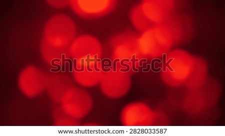 A close-up abstract view of out-of-focus red lights creating a bokeh effect, perfect for festive or energetic backgrounds.