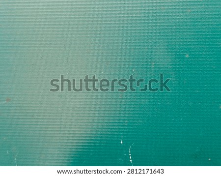 A close-up abstract view of a textured surface featuring fine horizontal lines and subtle color variations, creating a modern and clean backdrop.