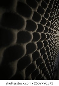 Close-Up of Acoustic Foam Panel with Hexagonal Texture – Soundproof Wall Material for Studio or Audio Room Treatment in Low Light