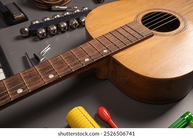 Close-up of acoustic guitar with wooden fretboard alongside various percussion instruments including bells, maracas, and tambourine. Folk and acoustic music concept showcasing traditional instruments. - Powered by Shutterstock