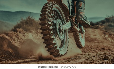Close-Up Action Shot of a Motocross Motorcycle Kicking Up Dust on an Off-Road Trail, Capturing Speed and Excitement with a Muddy Rear Wheel