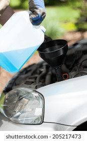 Close-up Of Adding Windshield Washer Fluid On A Car