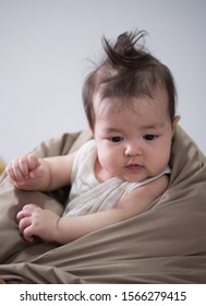 Close-up Adorable Baby With Messy Hair In Babysitting.Happy Baby Concept.