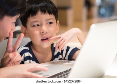 Closeup, Adorable Little Asian Boy Studying Mathematics Lessons From Laptop Computer Taught By Preteen Brother. Brotherhood, E-learning, Gamification, Social Media, Online Learning & Education.