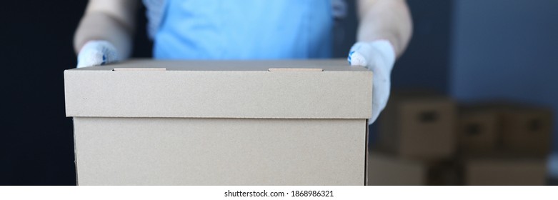 Close-up Of Adult Person Carrying Stack Of Boxes. Worker In Uniform Deliver Cartons With Personal Stuff. Construction Site. Renovation And Interior Design Concept