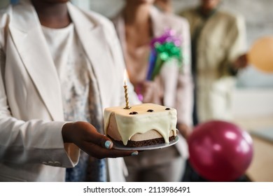 Close-up Of African American Businesswoman Having Party With Her Colleagues And Carrying A Cake With Lightened Candle In The Office.