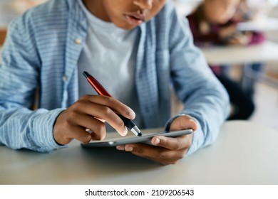 Close-up Of African American Elementary Student Using Digital Tablet During Computer Class At School. 