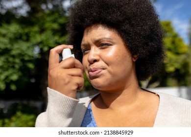 Close-up Of African American Mid Adult Woman Using Asthma Inhale. Unaltered, Healthcare, Asthmatic, Reliever Asthma Inhaler, Inhaling And Illness Concept.