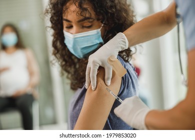 Close-up Of An African American Teenager Girl Receiving A Vaccine Due To Coronavirus Pandemic.