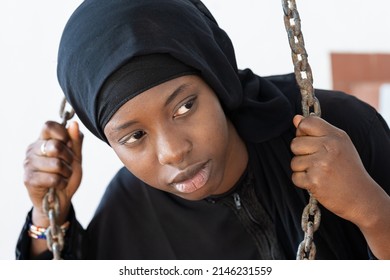 Close-up Of An African Girl Breaking Free From The Chains Of Tradition And Cultural Strings; Social Issue Of Globalization Affecting Third World Youth