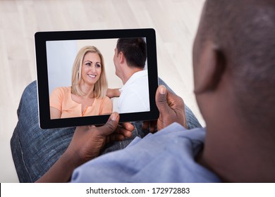 Close-up Of African Man Watching Video On Digital Tablet