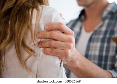 Closeup of aggressive man hand grabbed woman shoulder