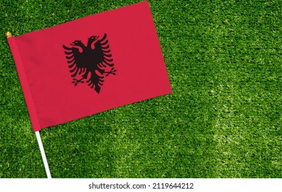 Close-up of Albania flag against closed up view of grass - Powered by Shutterstock