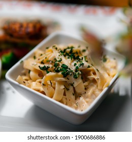 Closeup Of Alfredo Pasta With Herbs In A Bowl