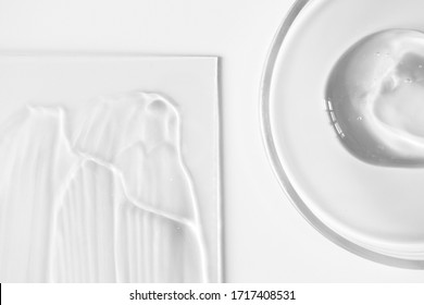 Close-up aloe gel in glass petri dish and transparent skin care lotion on glass on white background, above. Pure texture hydration shampoo or mask