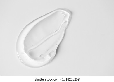 Close-up Aloe Gel Smear On White Background And Copy Space. Pure Transparent Facial Cleanser, Peeling, Shampoo Or Shower Gel, Top View