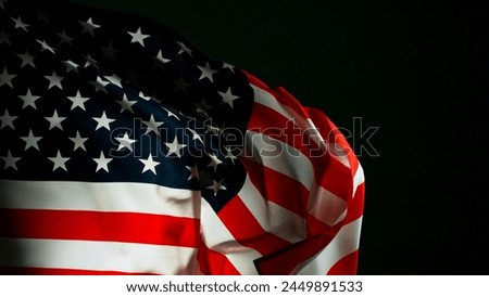 Closeup of American flag on black background, freeze motion