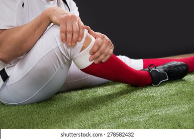 Close-up Of A American Football Player With Injury In Leg On Field