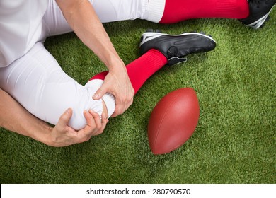 Close-up Of A American Football Player With Injury In Leg On Field