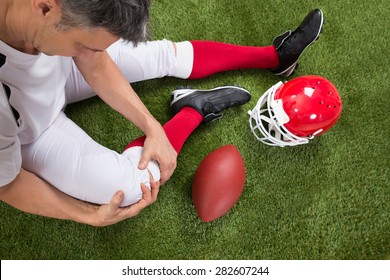 Close-up Of A American Football Player With Injury In Leg On Field