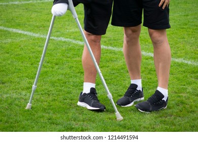 close-up of ampute soccer player and team friend - Powered by Shutterstock